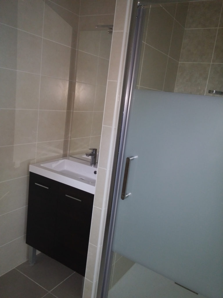 Photographie montrant l’installation d’une douche entièrement neuve.