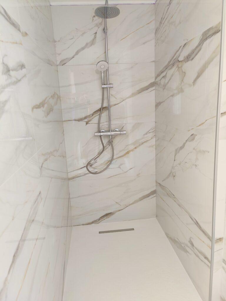 Création d'une magnifique douche avec parement en marbre et pose d'une colonne de douche